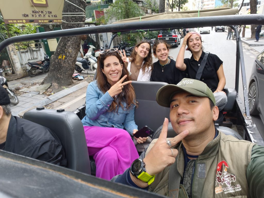 Local guide and guests enjoying a Hanoi Jeep Tour adventure.