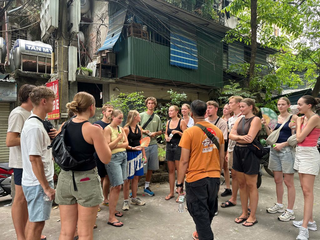 Local guide sharing cultural stories during a Hanoi Backstreet Tour.