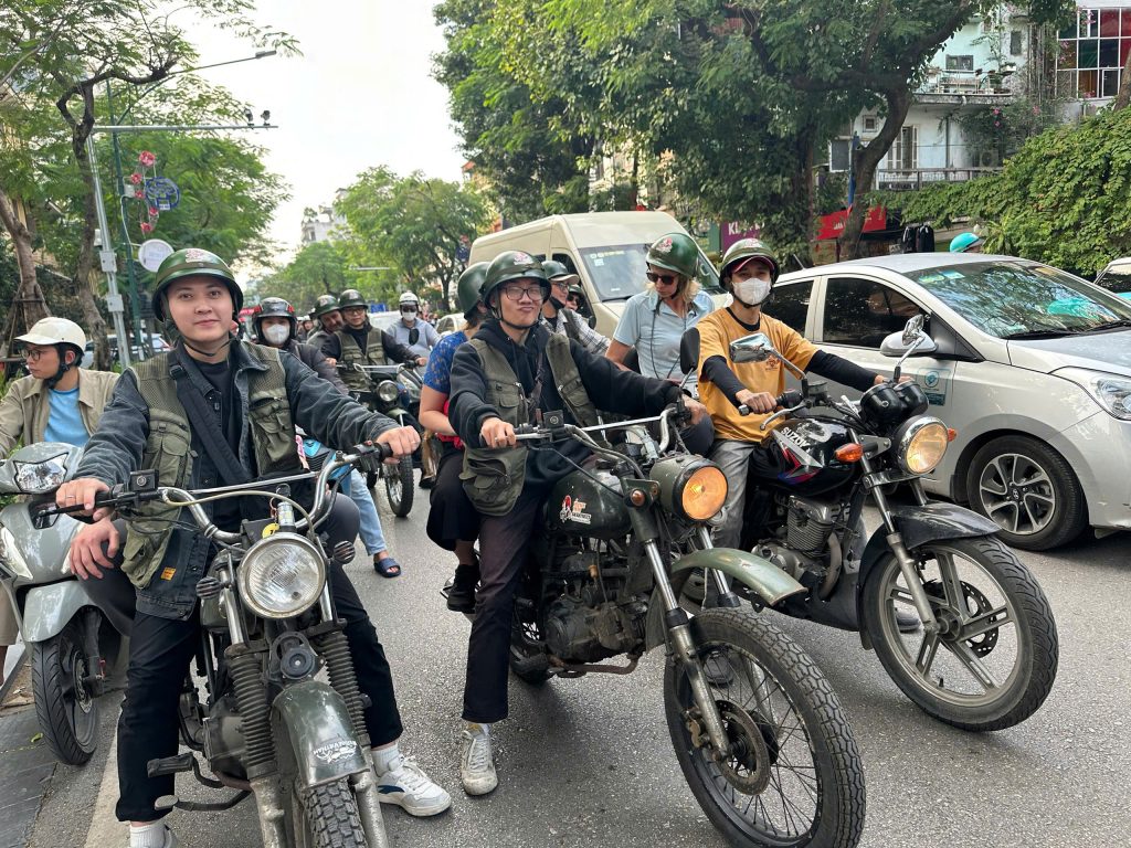 Group of travelers exploring Hanoi on a guided Backstreet Motorcycle Tour.