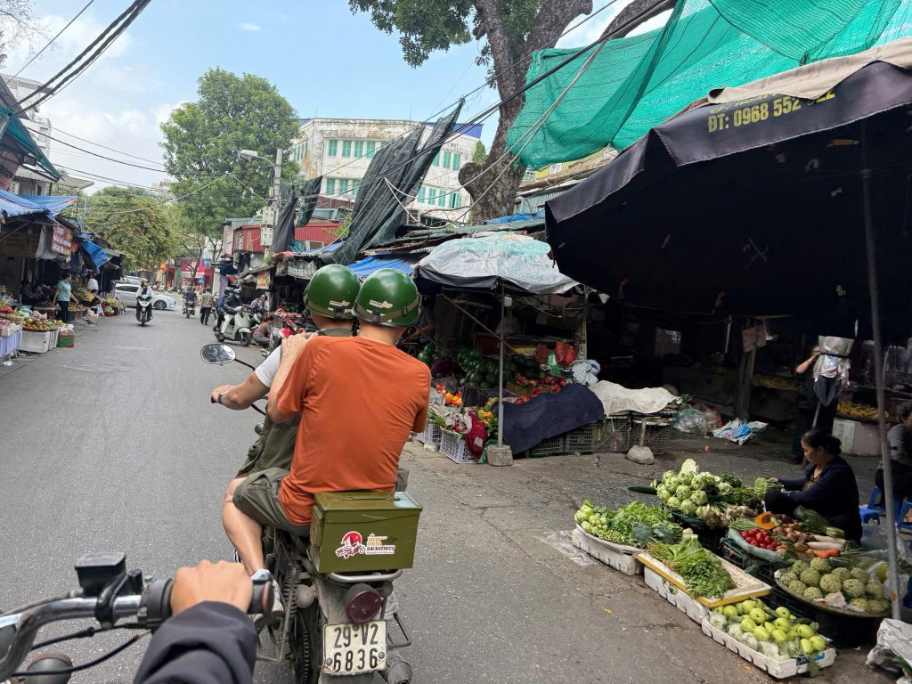 Exploring a traditional local market on a Hanoi Backstreet Motorbike Tour.