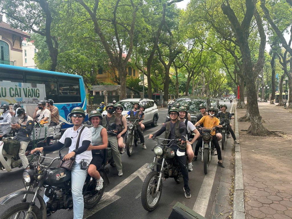 Group of travelers exploring Hanoi on a guided Backstreet Motorcycle Tour.