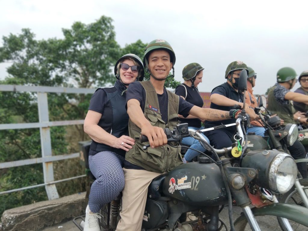 Guest riding with an experienced local driver on a safe Hanoi Motorbike Tour.