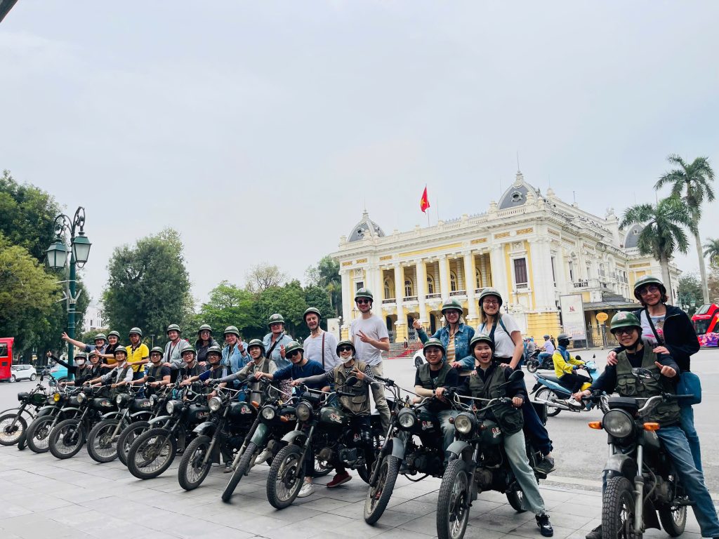 "Motorbike tour group stopping at Hanoi Opera House"
