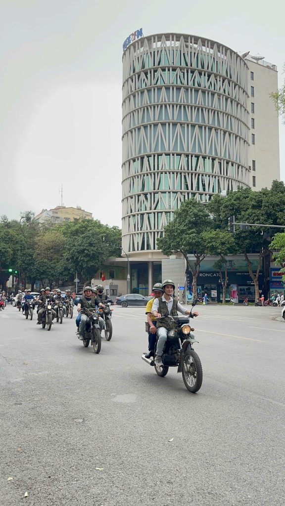 "Vintage Minsk motorcycles riding through Hanoi French Quarter"